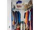 Neatly arranged closet with hanging clothes, shelves, and bags for efficient storage at 118 Congress St # F, Charleston, SC 29403