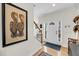 Bright foyer with hardwood floors, white front door with sidelights, and stairway at 118 Congress St # F, Charleston, SC 29403