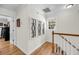 Upstairs hallway featuring hardwood floors, a window and artful decor at 118 Congress St # F, Charleston, SC 29403