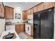 Functional kitchen with wood cabinets, white appliances, and a breakfast nook for casual dining at 118 Congress St # F, Charleston, SC 29403
