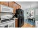 Modern kitchen with wood cabinets and open view to living and dining area at 118 Congress St # F, Charleston, SC 29403
