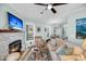Cozy living room with stone fireplace, ceiling fan, and comfortable seating area; bright and inviting at 118 Congress St # F, Charleston, SC 29403