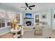 Comfortable living room featuring a fireplace, lots of natural light from the windows and hardwood floors at 118 Congress St # F, Charleston, SC 29403