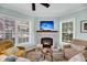 Bright living room with stone fireplace, comfortable seating, and natural light at 118 Congress St # F, Charleston, SC 29403