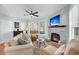 Cozy living room with stone fireplace, ceiling fan, and comfortable seating at 118 Congress St # F, Charleston, SC 29403