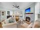 Cozy living room with stone fireplace, ceiling fan, and comfortable seating at 118 Congress St # F, Charleston, SC 29403