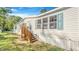 Charming home featuring bright, light blue shutters and a wooden entryway leading to the front door at 118 Regent St, Summerville, SC 29483