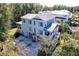 Aerial view of a two-story house with a metal roof, surrounded by lush trees and landscaping at 1212 Clonmel Pl, Mount Pleasant, SC 29464