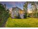 Charming home featuring a backyard with a screened-in porch, lush lawn, and mature trees at 1212 Clonmel Pl, Mount Pleasant, SC 29464