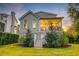 Backyard featuring a screened-in porch, set against a backdrop of a lush lawn and mature trees at 1212 Clonmel Pl, Mount Pleasant, SC 29464