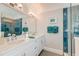 Bathroom featuring double sink vanity with white cabinets, luxurious countertops and a glass-enclosed shower at 1212 Clonmel Pl, Mount Pleasant, SC 29464