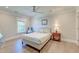 Bright bedroom with a large window, ceiling fan, hardwood floors, and a comfortable queen-sized bed at 1212 Clonmel Pl, Mount Pleasant, SC 29464
