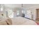 Bright bedroom with white furniture, ceiling fan, and three windows for natural light at 1212 Clonmel Pl, Mount Pleasant, SC 29464