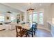 Bright dining room with modern chandelier, and views into living room, is great for entertaining at 1212 Clonmel Pl, Mount Pleasant, SC 29464