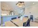 Dining area with stylish lighting, ample seating, shiplap accents, and seamless flow to the kitchen and staircase at 1212 Clonmel Pl, Mount Pleasant, SC 29464