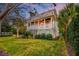 Beautiful two-story home with a covered porch, manicured lawn, and mature landscaping at 1212 Clonmel Pl, Mount Pleasant, SC 29464