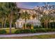Beautiful home featuring mature palm trees and well manicured landscaping, offering a welcoming entrance at 1212 Clonmel Pl, Mount Pleasant, SC 29464