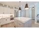 Modern kitchen with stainless steel appliances, custom cabinets, a center island, and open layout to the dining area at 1212 Clonmel Pl, Mount Pleasant, SC 29464