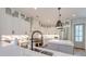 Modern kitchen with stainless steel appliances, custom cabinets, a large island, and elegant pendant lighting at 1212 Clonmel Pl, Mount Pleasant, SC 29464