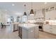 Well-appointed kitchen offers island seating and seamless transition to the adjacent living area at 1212 Clonmel Pl, Mount Pleasant, SC 29464