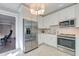 Modern kitchen with white cabinetry, stainless steel appliances, and stylish lighting at 1212 Clonmel Pl, Mount Pleasant, SC 29464