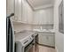 Well-organized laundry room equipped with washer, dryer, sink, and ample cabinet space at 1212 Clonmel Pl, Mount Pleasant, SC 29464