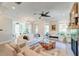 Spacious living room featuring modern furnishings, a cozy fireplace, and ample natural light creating a relaxing atmosphere at 1212 Clonmel Pl, Mount Pleasant, SC 29464