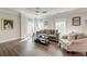 Bright living room featuring hardwood floors, decorative windows, and stylish furniture at 1212 Clonmel Pl, Mount Pleasant, SC 29464