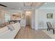 Open-concept living room featuring light wood floors, neutral furnishings, and seamless flow to the dining area and kitchen at 1212 Clonmel Pl, Mount Pleasant, SC 29464