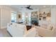 Elegant living room features a fireplace, built-ins, and ample natural light from large windows at 1212 Clonmel Pl, Mount Pleasant, SC 29464