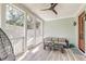 Relaxing screened-in porch with cozy seating and sun-drenched wood-look tile flooring at 1212 Clonmel Pl, Mount Pleasant, SC 29464