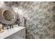 Chic powder room featuring modern fixtures, a stylish vanity, and patterned wallpaper for a touch of elegance at 1212 Clonmel Pl, Mount Pleasant, SC 29464