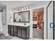 Modern bathroom featuring a vanity with dark cabinetry, a large mirror, and a view into a walk-in closet at 123 Mcdonald Ct, Summerville, SC 29485