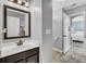 Bathroom with dark vanity, modern mirror, tile floors, and doorway into bedroom at 123 Mcdonald Ct, Summerville, SC 29485