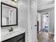 Bathroom with dark vanity, modern mirror, tile floors, and doorway into bedroom at 123 Mcdonald Ct, Summerville, SC 29485