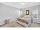 Cozy bedroom featuring neutral walls, carpet, and decorative mirror, plus abundant natural light from the two windows at 123 Mcdonald Ct, Summerville, SC 29485