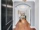 Elegant foyer with gleaming hardwood floors, arched doorway, and views of the kitchen, creating a welcoming entrance to the home at 123 Mcdonald Ct, Summerville, SC 29485