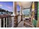 Inviting front porch featuring stone pillars, white railings, and rocking chairs, perfect for relaxing and enjoying the neighborhood views at 123 Mcdonald Ct, Summerville, SC 29485