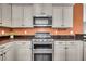 Well-equipped kitchen with stainless steel stove and oven, granite countertops, and neutral cabinets, offering a modern and functional space at 123 Mcdonald Ct, Summerville, SC 29485