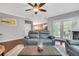Open-concept living room with dark wood floors, gray sofa, fireplace and access to the kitchen and backyard at 123 Mcdonald Ct, Summerville, SC 29485