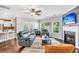 Inviting living room with hardwood floors, a cozy fireplace, and abundant natural light from the multiple windows at 123 Mcdonald Ct, Summerville, SC 29485