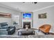Cozy living room with a fireplace, plush seating, and a mounted television, providing a comfortable space for relaxation and entertainment at 123 Mcdonald Ct, Summerville, SC 29485