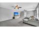 Open-concept living room with gray walls, carpet, a sectional sofa, and a media console with a large TV at 123 Mcdonald Ct, Summerville, SC 29485
