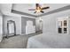 A gray main bedroom with a ceiling fan, a dresser, and a mirror in the corner at 123 Mcdonald Ct, Summerville, SC 29485