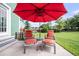 Cozy patio area with comfortable seating and a red umbrella, perfect for relaxing outdoors at 123 Mcdonald Ct, Summerville, SC 29485