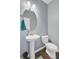 Bathroom featuring wood floors, toilet, sink and an oval mirror, great for guests at 134 Longford Dr, Summerville, SC 29483