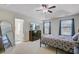 Bright primary bedroom with tray ceiling, carpeted floors, and en-suite bathroom at 134 Longford Dr, Summerville, SC 29483