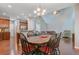 Open dining room with a modern chandelier, hardwood floors and adjacent to the kitchen at 134 Longford Dr, Summerville, SC 29483
