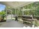 Relaxing screened patio equipped with grilling stations and views of the wooded backyard at 134 Longford Dr, Summerville, SC 29483