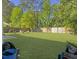 A spacious backyard has seating and is surrounded by a wooden fence at 139 Pointer Dr, Goose Creek, SC 29445